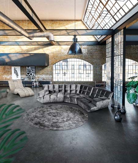 Graues samtiges Bretz Sofa Cloud 7 steht in einer Loftwohnung mit dem Cloud 7 Relaxsessel nebendran